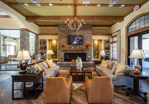 a living room with couches and chairs and a fireplace