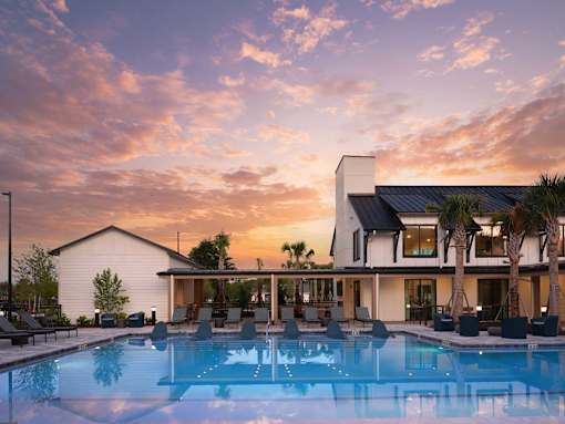 A modern house with a pool in the foreground.