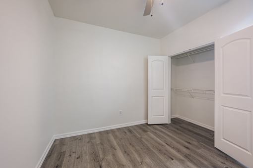 A room with a wooden floor and white walls.