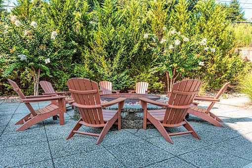 Four chairs and a table are set up on a patio.