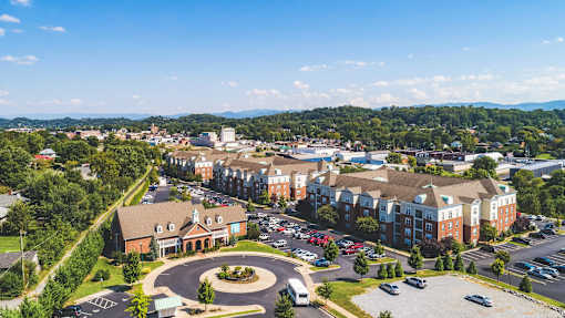 A large building complex with a circular driveway in front.
