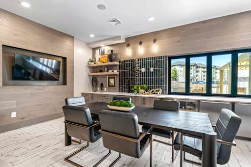 A modern dining room with a large table and chairs.