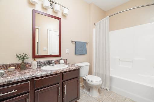 A bathroom with a sink, toilet, and bathtub.