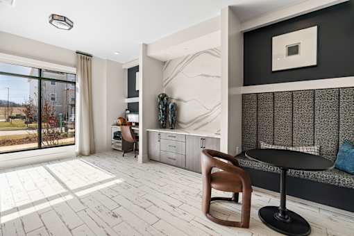 A modern living room with a wooden chair and a black table.