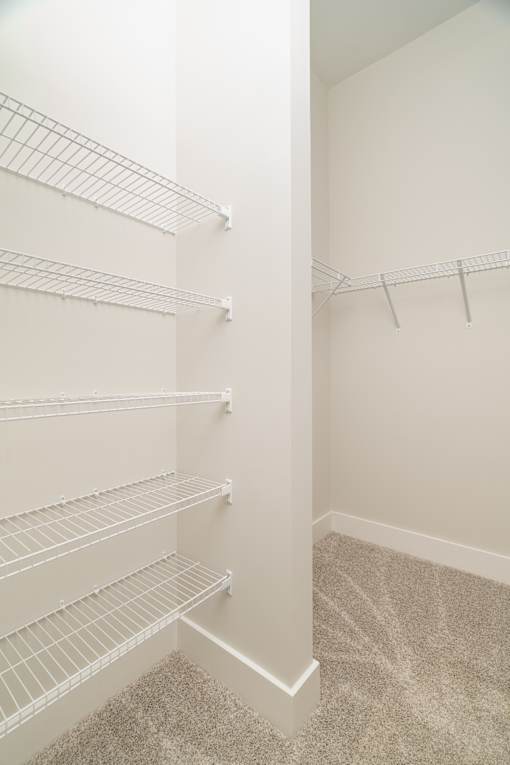 Empty white shelves in a room.