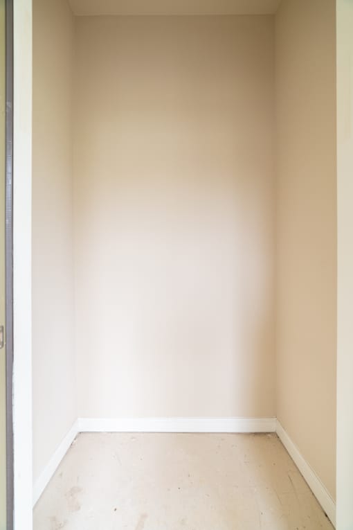 A white room with a wooden floor and white walls.