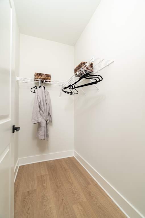 A hallway with a coat hanging on a rack.