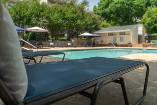 A blue pool table in the foreground with a pool table in the background.