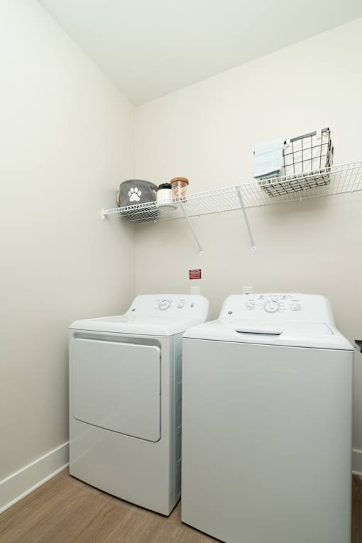 Two front loading washing machines in a laundry room.