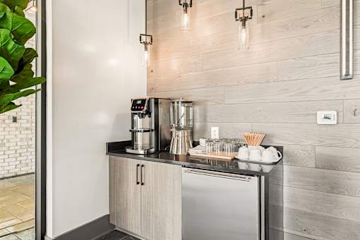 A modern kitchen with a stainless steel refrigerator and wooden cabinets.