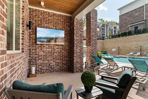 A small patio with a couch and chairs.