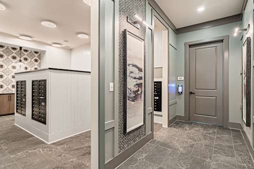 A hallway with a grey floor and a white ceiling with lights.