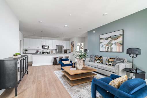 A modern living room with a blue couch and a wooden coffee table.