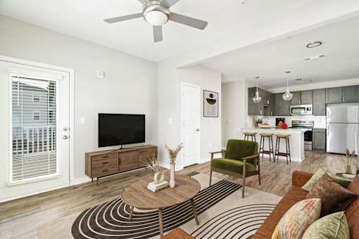 A living room with a brown sofa and a wooden coffee table.