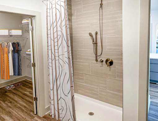 A bathroom with a shower curtain and a white bathtub.