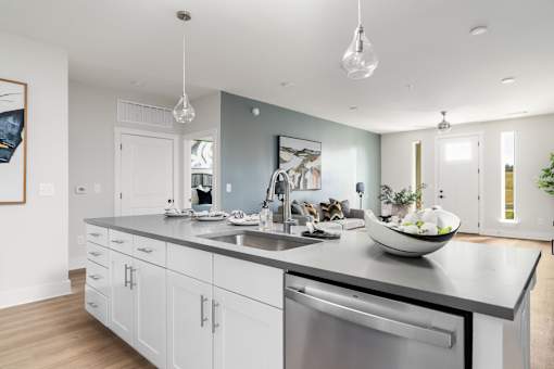 A modern kitchen with a large island and stainless steel appliances.