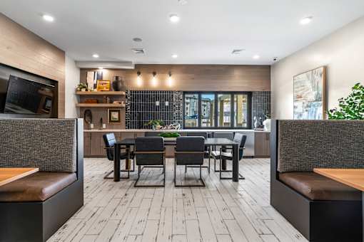 A modern dining area with a long table and chairs.