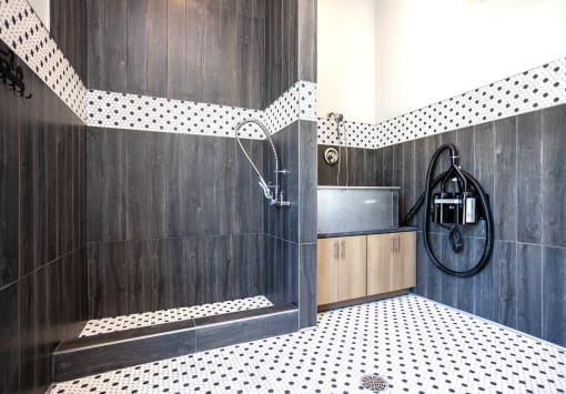 a bathroom with black and white tile