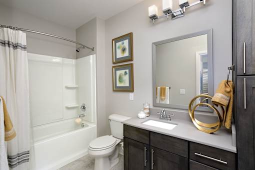 A bathroom with a white toilet, a white sink, and a white bathtub.