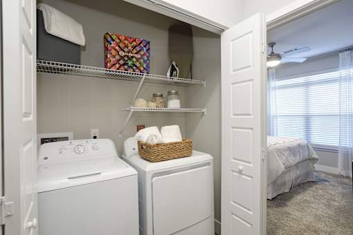 A small laundry room with a washer and dryer.