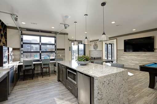 A modern kitchen with a pool table.