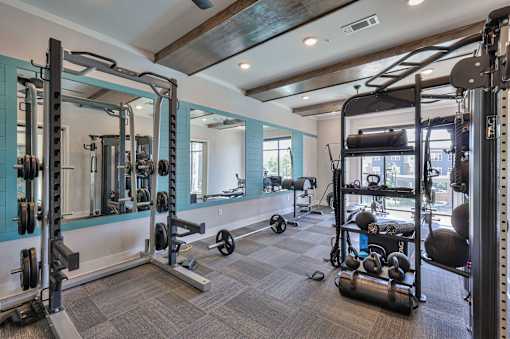 A well-equipped gym with a variety of exercise equipment.