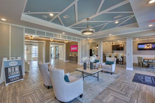 A living room with a leasing sign in the foreground.