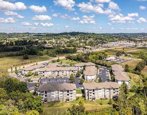 an aerial view of an apartment complex with a city in the background