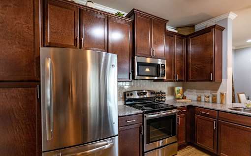 a kitchen with stainless steel appliances and wooden cabinets