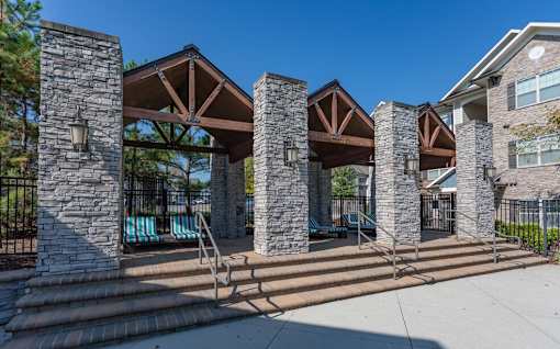 a pavilion with steps and a pool in front of a building