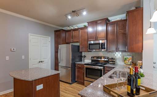 a kitchen with stainless steel appliances and granite counter tops