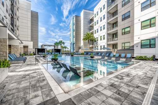 a swimming pool in the middle of some tall buildings