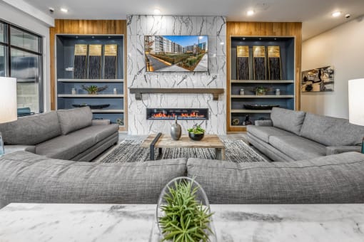 a living room with couches and a table and a fireplace