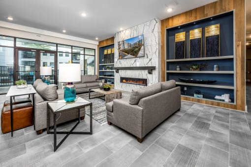 a living room with couches and a table and a fireplace