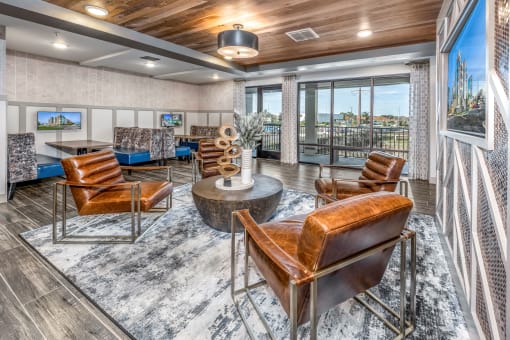 a living room with leather chairs and a table