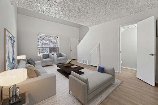 A living room with a couch, a coffee table, and a painting on the wall.