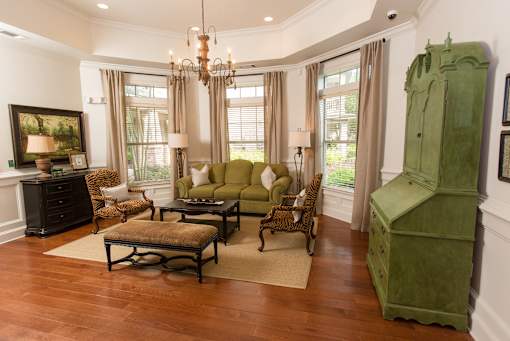 A living room with a green sofa and a wooden coffee table.