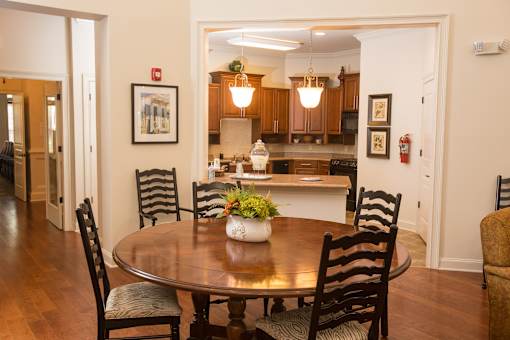 A dining room with a table and chairs.