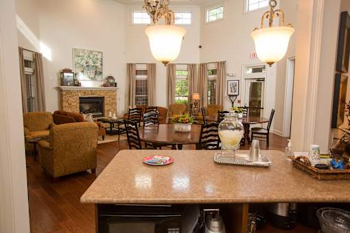 A dining room with a table set for a meal.