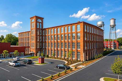 A large red brick building with a water tower in the background.