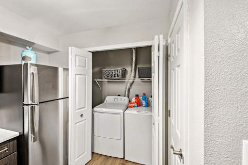 A small laundry room with a washer and dryer.