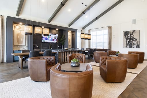 a large living room with leather furniture and a bar