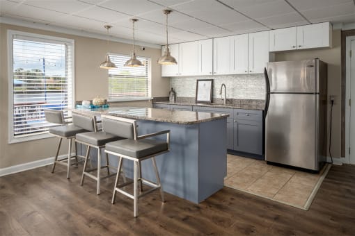 a kitchen with white cabinets and a stainless steel refrigerator  at Waterview at Rocky Point, Tampa