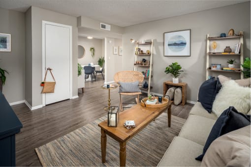 a living room with a couch coffee table and bookshelves at Waterview at Rocky Point, Tampa, FL