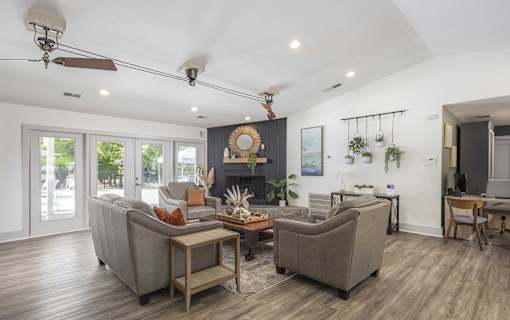 A living room with a grey couch, a coffee table, and a fireplace.