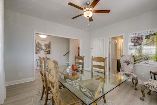 A dining room with a glass table and chairs.