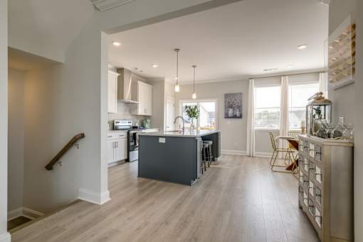 A kitchen with a dining table and chairs.