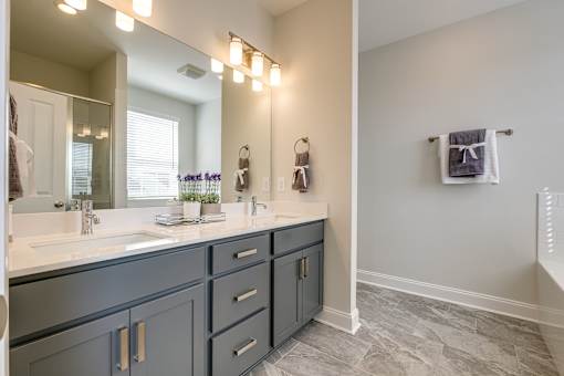 A bathroom with a vanity and a mirror.
