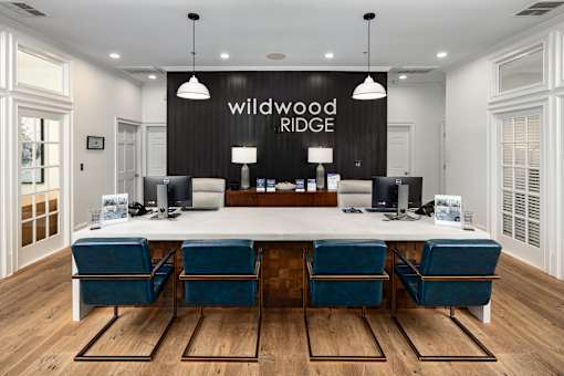 A conference room with a long table and chairs, and a sign that reads "Wildwood Ridge.".
