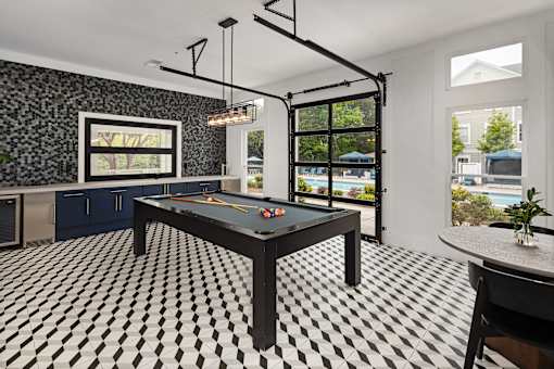 A black and white checkered floor in a room with a pool table.